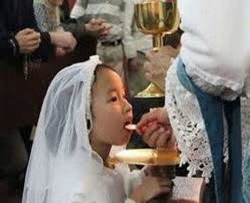 Little girl receiving Holy Communion